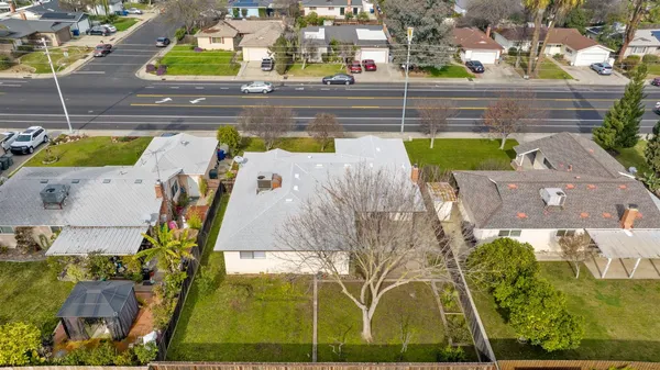 an aerial view of a swimming pool with outdoor seating