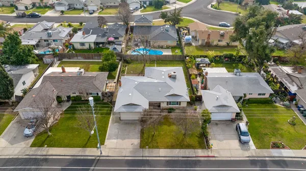 an aerial view of a house with garden space and street view