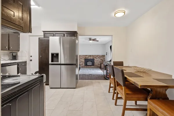a kitchen with a refrigerator sink and cabinets