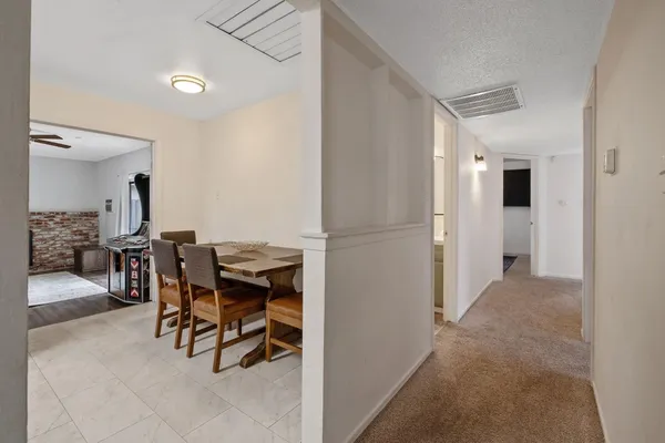 a view of kitchen with furniture and refrigerator