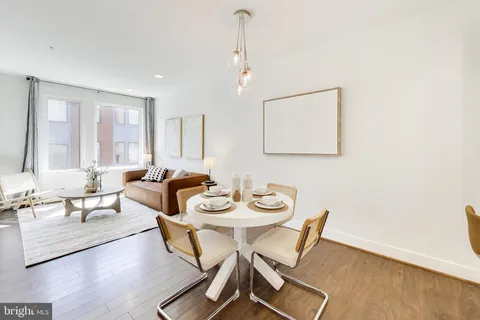 a kitchen with a sink cabinets and wooden floor