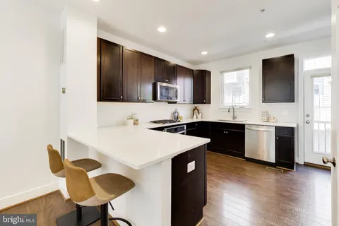 a kitchen with a sink stove top oven and cabinets