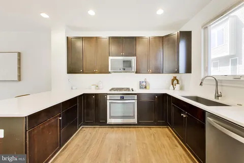 a kitchen with a sink and a refrigerator