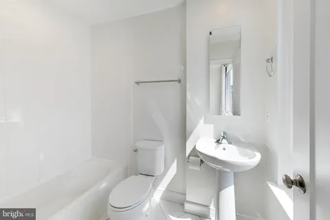 a bedroom with furniture and a large window