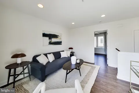 a bathroom with a sink vanity mirror and toilet