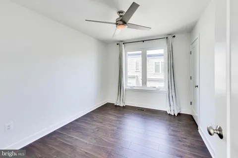 a view of a balcony with two chairs and a barbeque