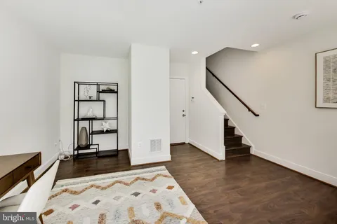 a living room with furniture a window and a table