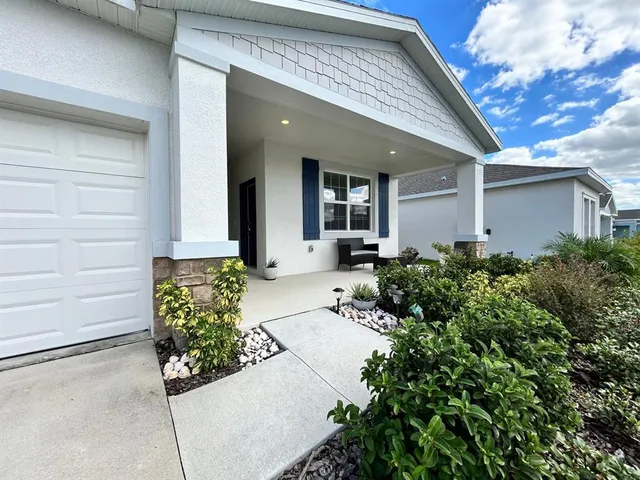 a front view of a house with lots of green space