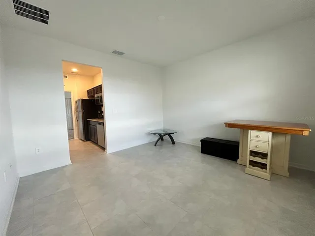 a view of a livingroom with furniture and a ceiling fan