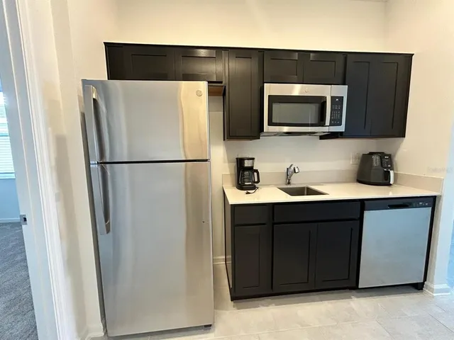 a white refrigerator freezer sitting in a kitchen