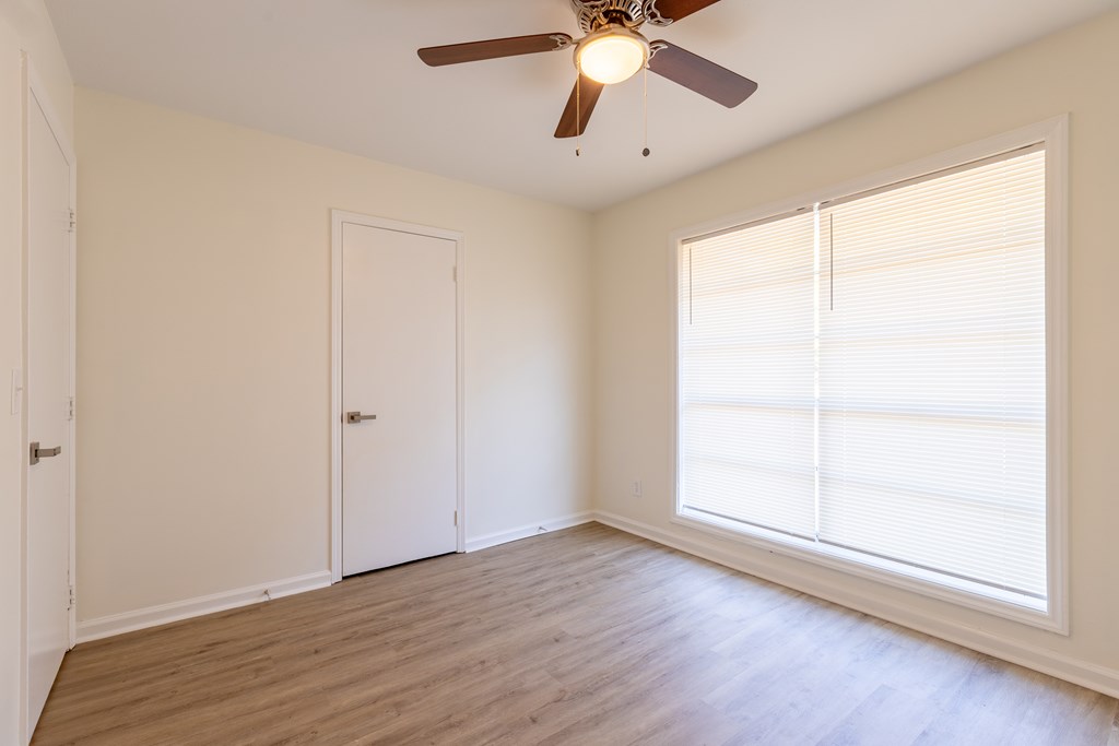 4813 Rowland Court Columbus, GA 31907 - Photo 11 of 16 an empty room with wooden floor fan and windows