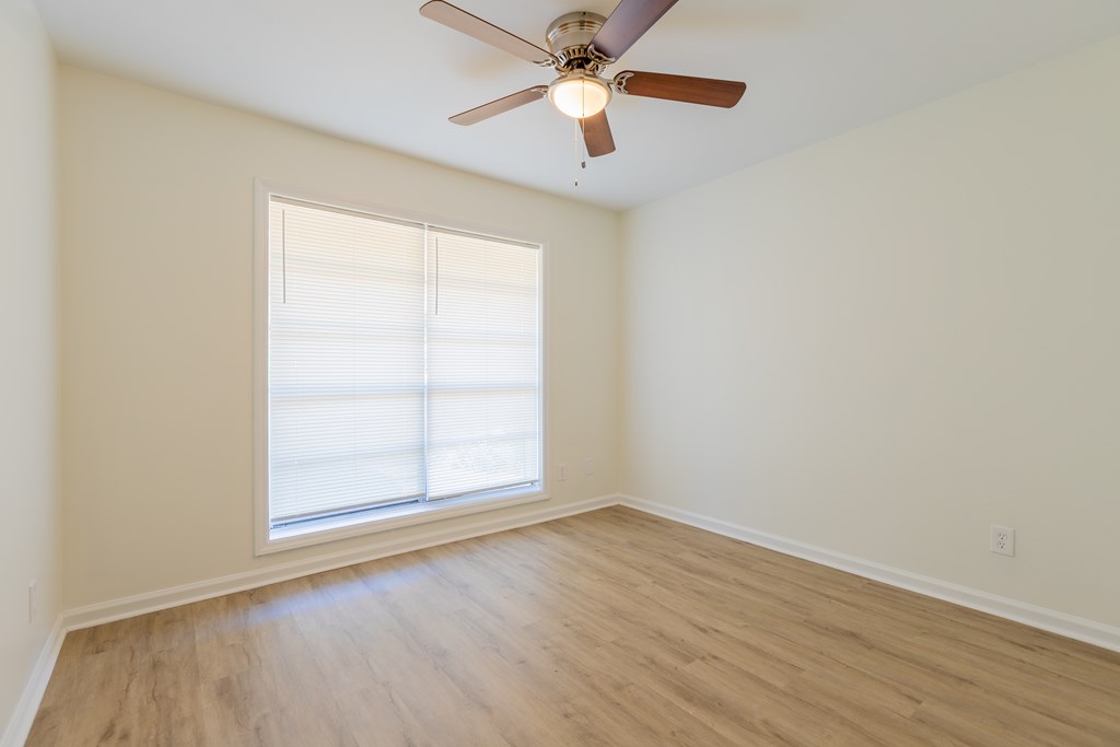 4813 Rowland Court Columbus, GA 31907 - Photo 12 of 16 an empty room with wooden floor fan and windows