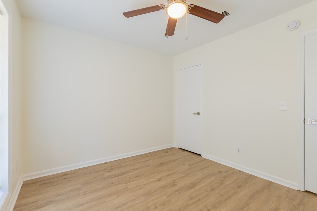 4813 Rowland Court Columbus, GA 31907 - Photo 13 of 16 an empty room with a ceiling fan and wooden floor