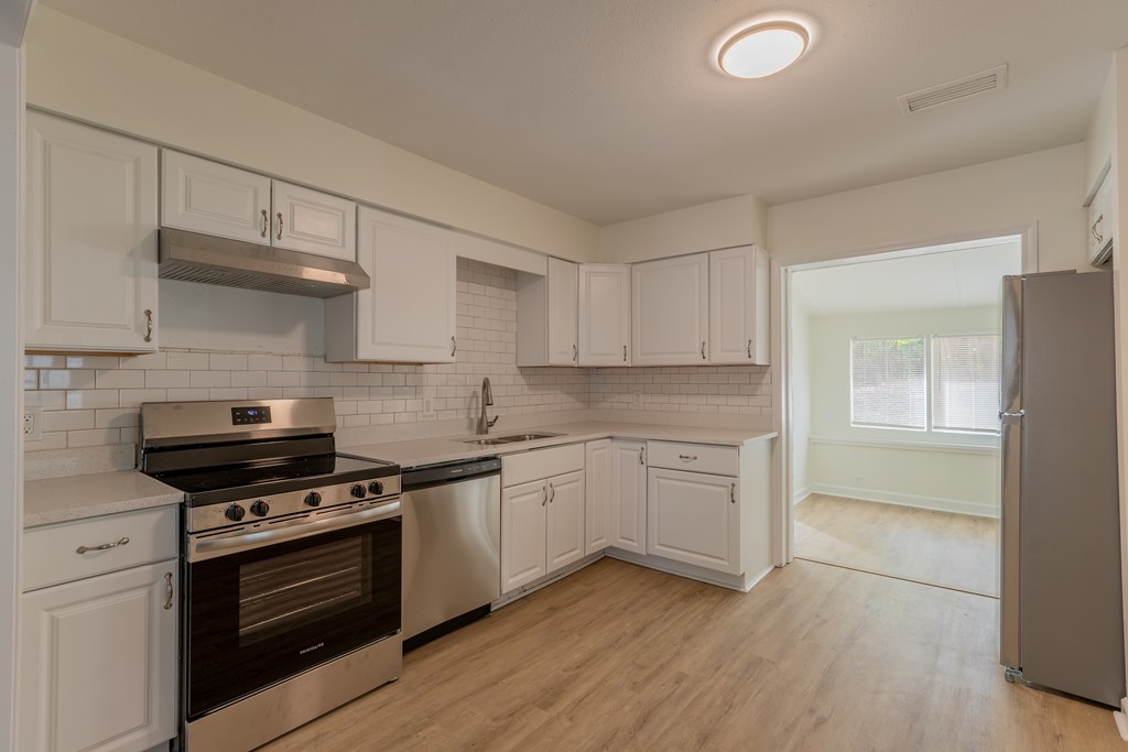 4813 Rowland Court Columbus, GA 31907 - Photo 4 of 16 a kitchen with stainless steel appliances white cabinets and a stove top oven