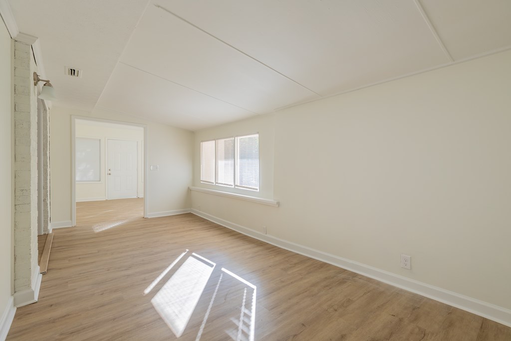 4813 Rowland Court Columbus, GA 31907 - Photo 8 of 16 an empty room with wooden floor and windows
