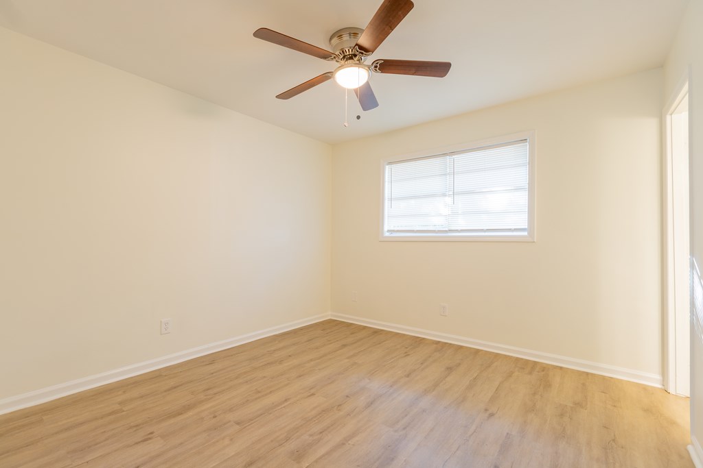 4813 Rowland Court Columbus, GA 31907 - Photo 9 of 16 an empty room with wooden floor and windows