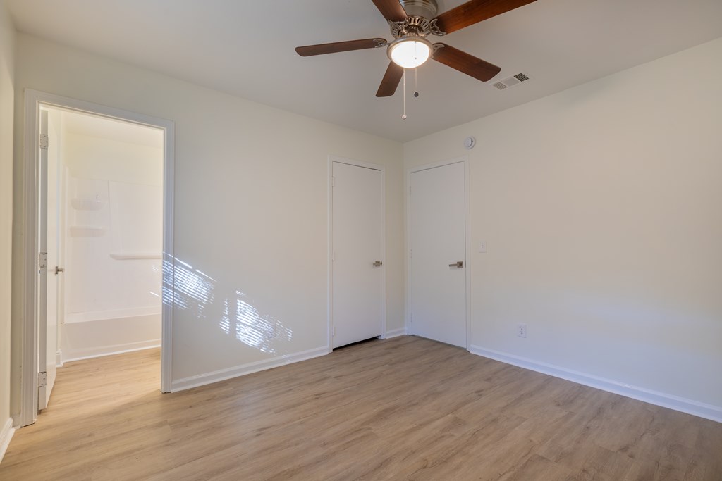 4813 Rowland Court Columbus, GA 31907 - Photo 10 of 16 an empty room with wooden floor and fan