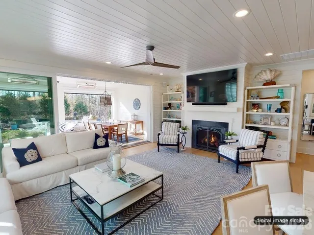 a living room with furniture a fireplace and a flat screen tv