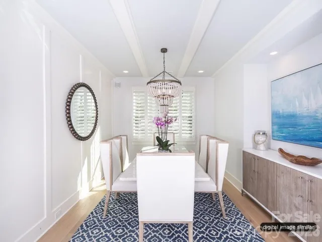 a dining room with furniture wooden floor and a rug