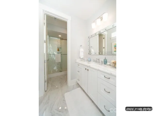 a bathroom with a sink a mirror and a shower
