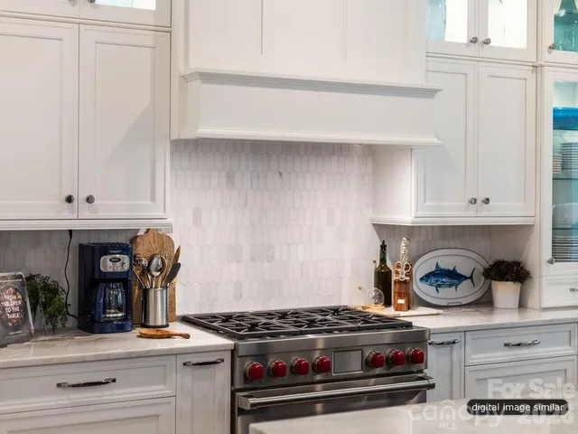 a kitchen with a stove and wooden floor