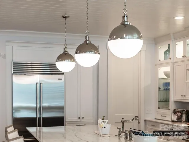 a kitchen with stainless steel appliances a refrigerator a stove a microwave and cabinets