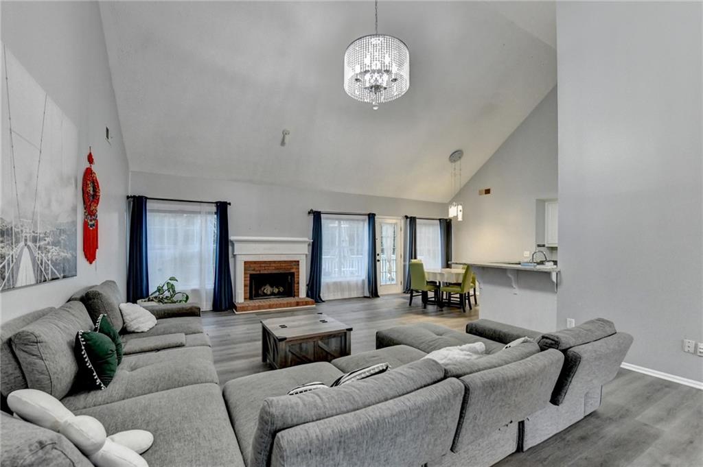 235 Ruby Forest Parkway Suwanee, GA 30024 - Photo 11 of 59 a living room with furniture kitchen view and a fireplace