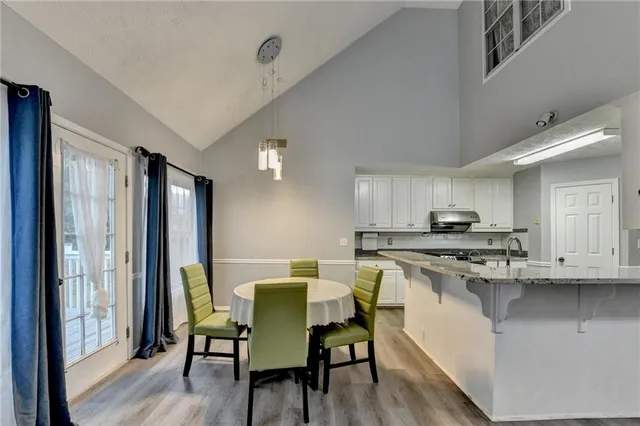 a living room with furniture dining table and a chandelier