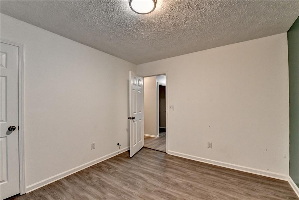 235 Ruby Forest Parkway Suwanee, GA 30024 - Photo 33 of 59 a view of an empty room with wooden floor and a window