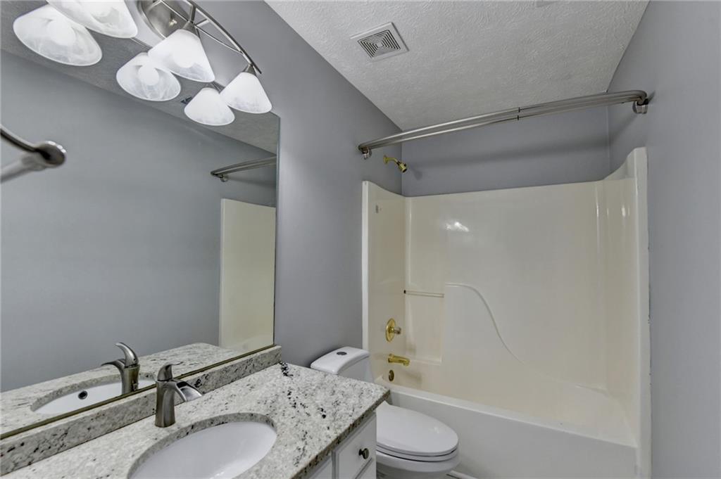 235 Ruby Forest Parkway Suwanee, GA 30024 - Photo 34 of 59 a bathroom with a sink a toilet and shower