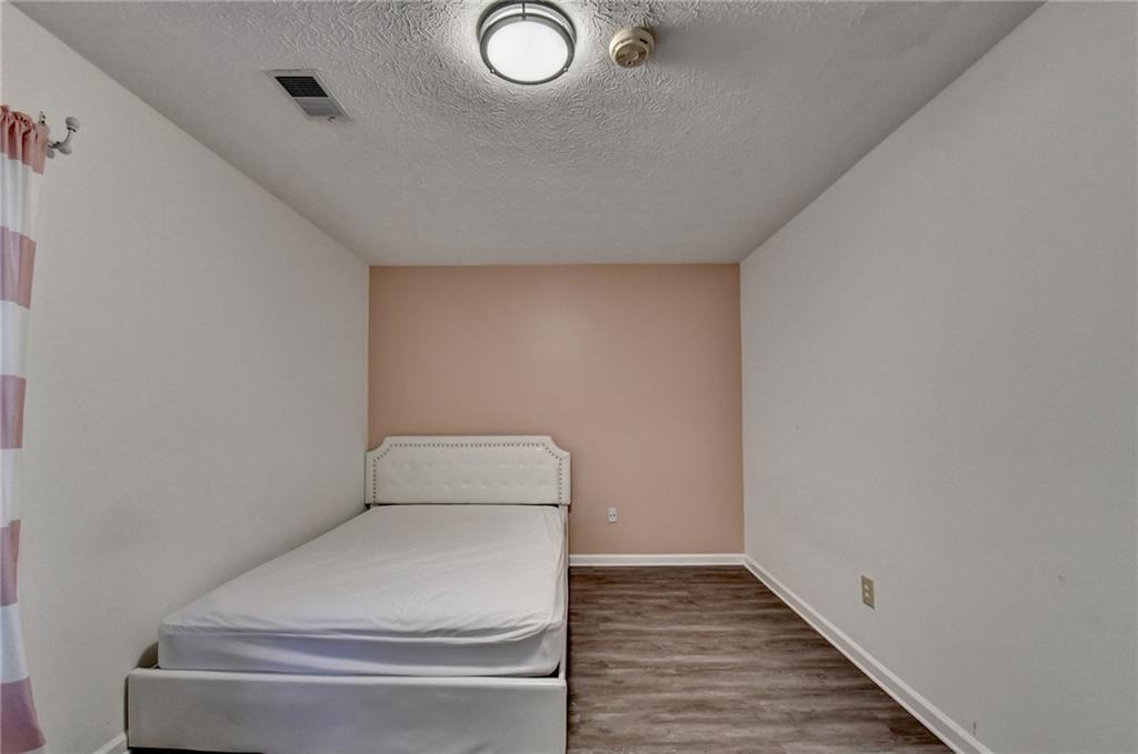 235 Ruby Forest Parkway Suwanee, GA 30024 - Photo 36 of 59 a bathroom with a toilet and wooden floor