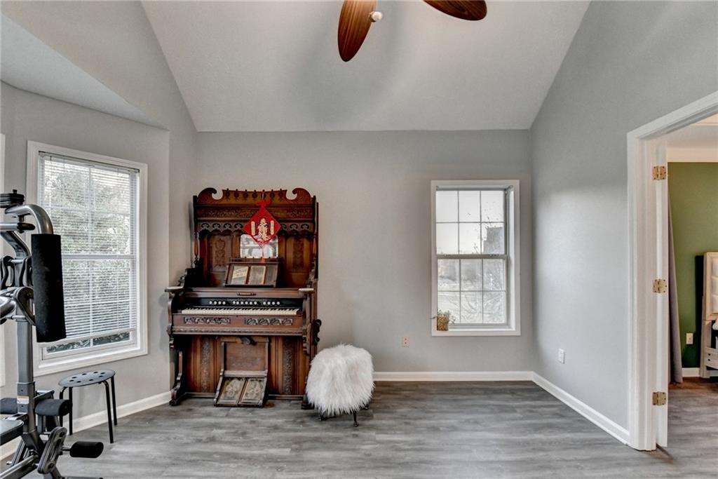 235 Ruby Forest Parkway Suwanee, GA 30024 - Photo 46 of 59 a view of an empty room with a window and wooden floor