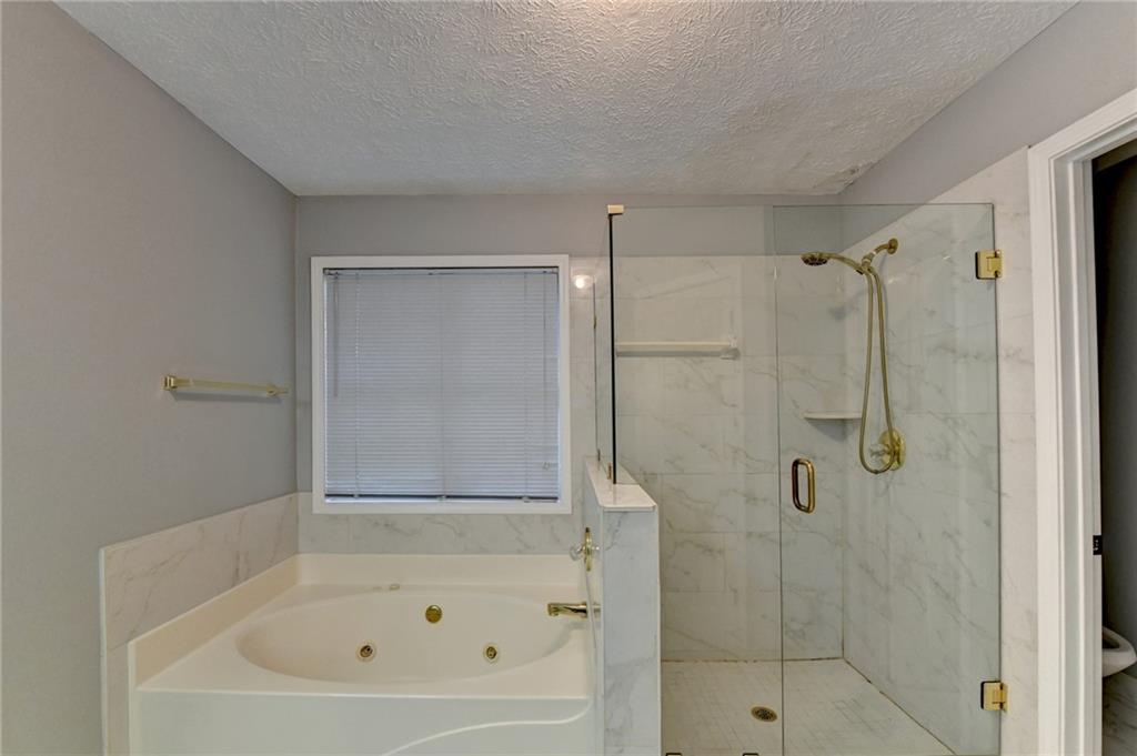 235 Ruby Forest Parkway Suwanee, GA 30024 - Photo 49 of 59 a bathroom with a bathtub