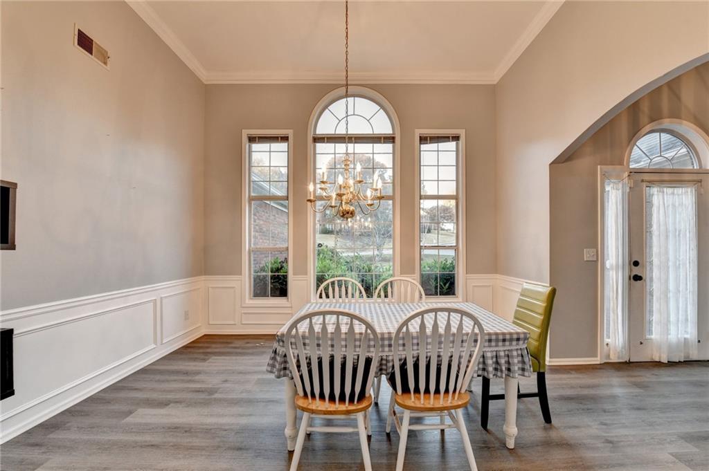 235 Ruby Forest Parkway Suwanee, GA 30024 - Photo 7 of 59 a view of a dining room with furniture window and wooden floor