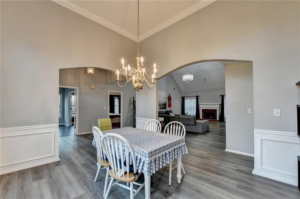 235 Ruby Forest Parkway Suwanee, GA 30024 - Photo 10 of 59 a view of a dining room with furniture and wooden floor