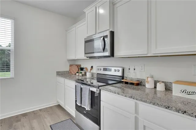 a kitchen with appliances a sink and cabinets
