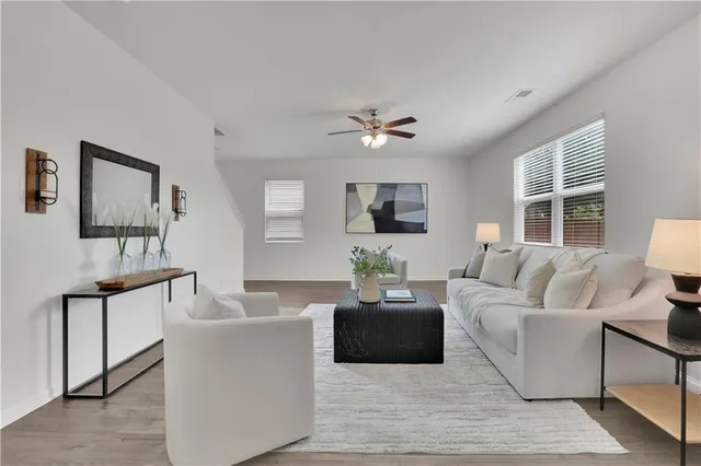 a living room with furniture a lamp and a flat screen tv