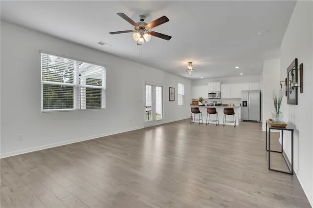 a view of a work space with wooden floor and a large window