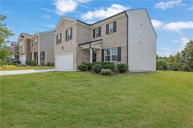 a front view of a house with a garden