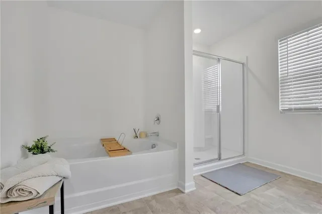a bathroom with a tub and shower