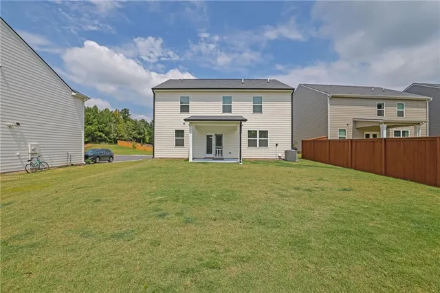 a front view of a house with garden and porch