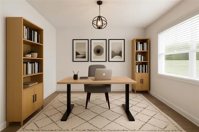a view of a workspace with furniture and a window