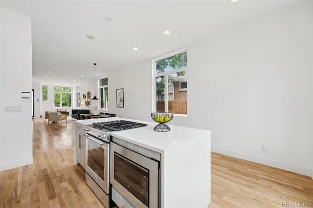 a kitchen with a stove and a wooden floors