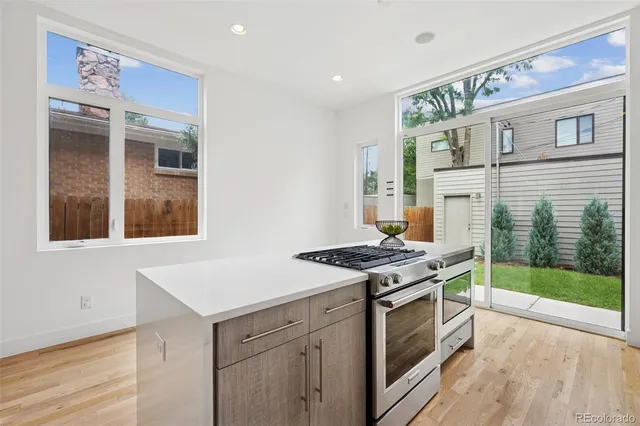 a kitchen with a stove and a wooden cabinets