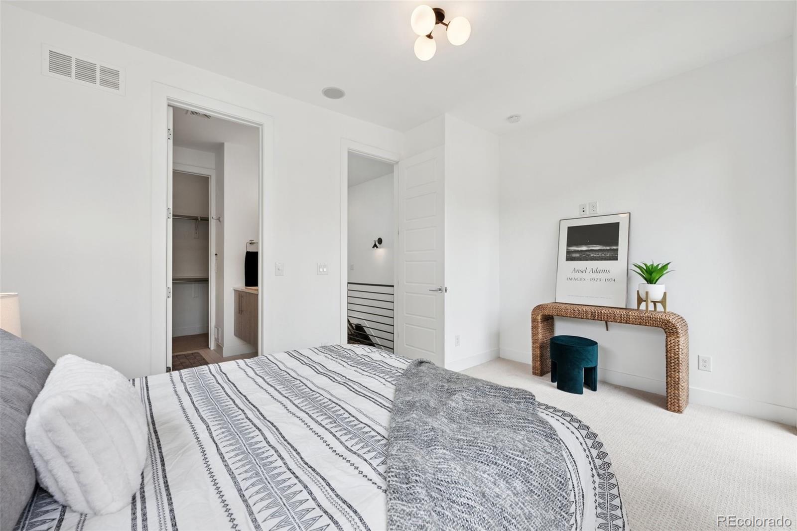 1833 East Jewell Avenue Denver, CO 80210 - Photo 19 of 41 a bedroom with a bed and a flat screen tv