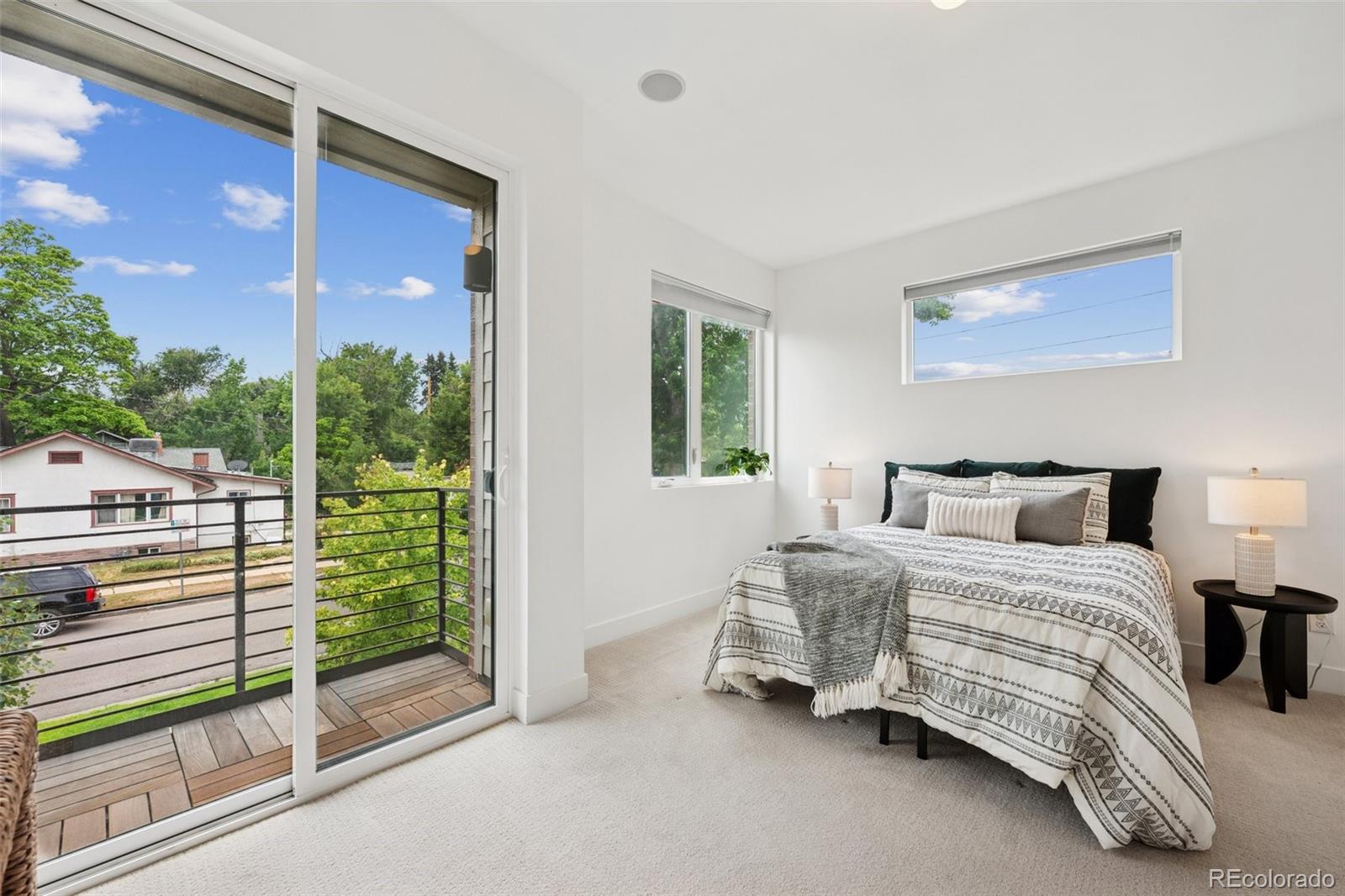 1833 East Jewell Avenue Denver, CO 80210 - Photo 20 of 41 a bedroom with a bed and a balcony view