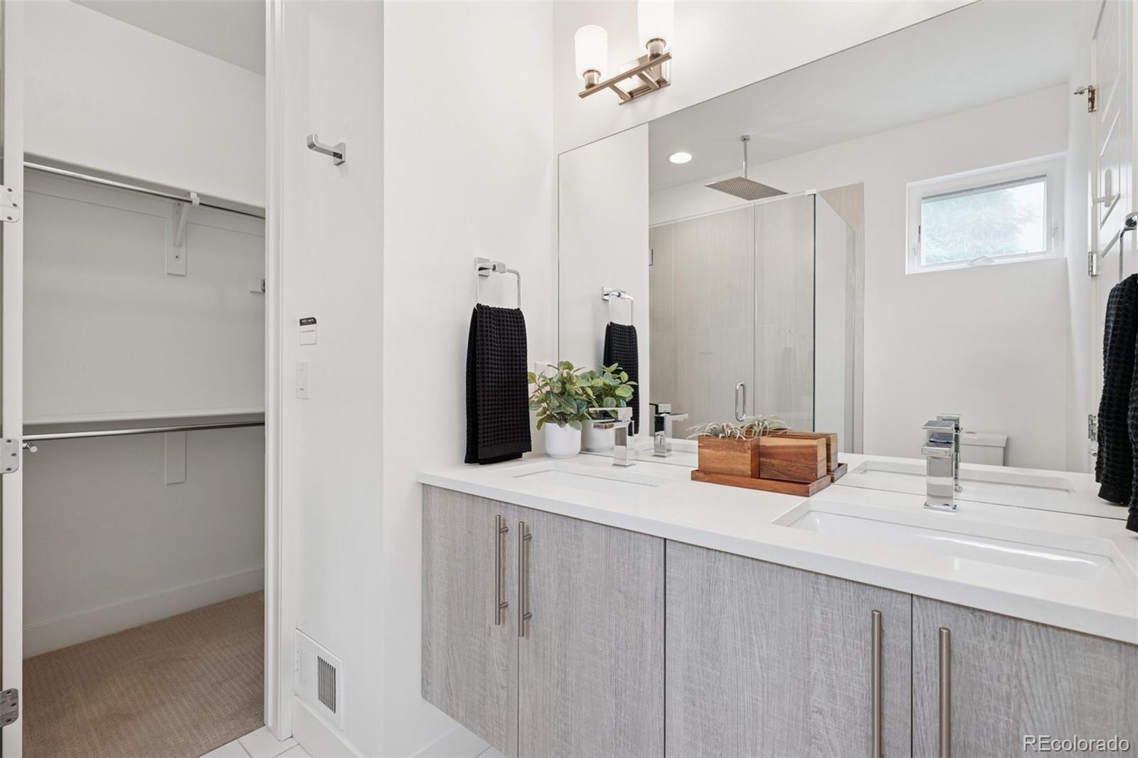 1833 East Jewell Avenue Denver, CO 80210 - Photo 23 of 41 a bathroom with a sink and a mirror