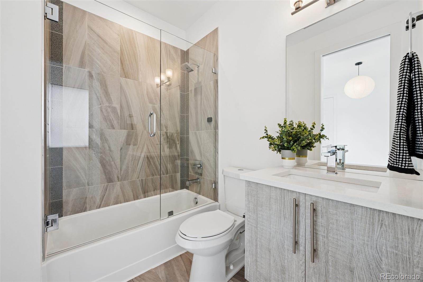 1833 East Jewell Avenue Denver, CO 80210 - Photo 28 of 41 a bathroom with a sink toilet and shower