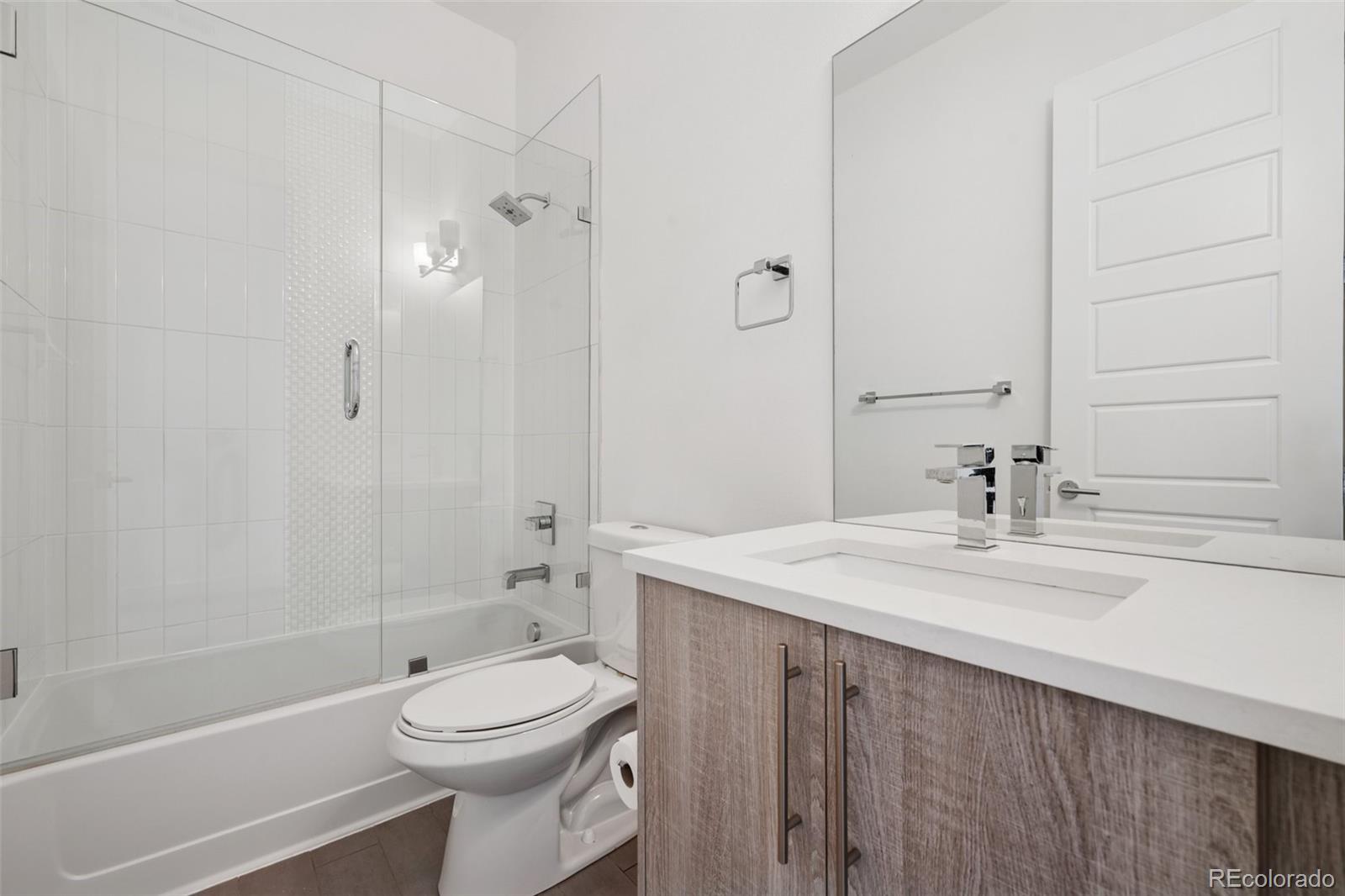 1833 East Jewell Avenue Denver, CO 80210 - Photo 37 of 41 a bathroom with a sink a toilet and shower