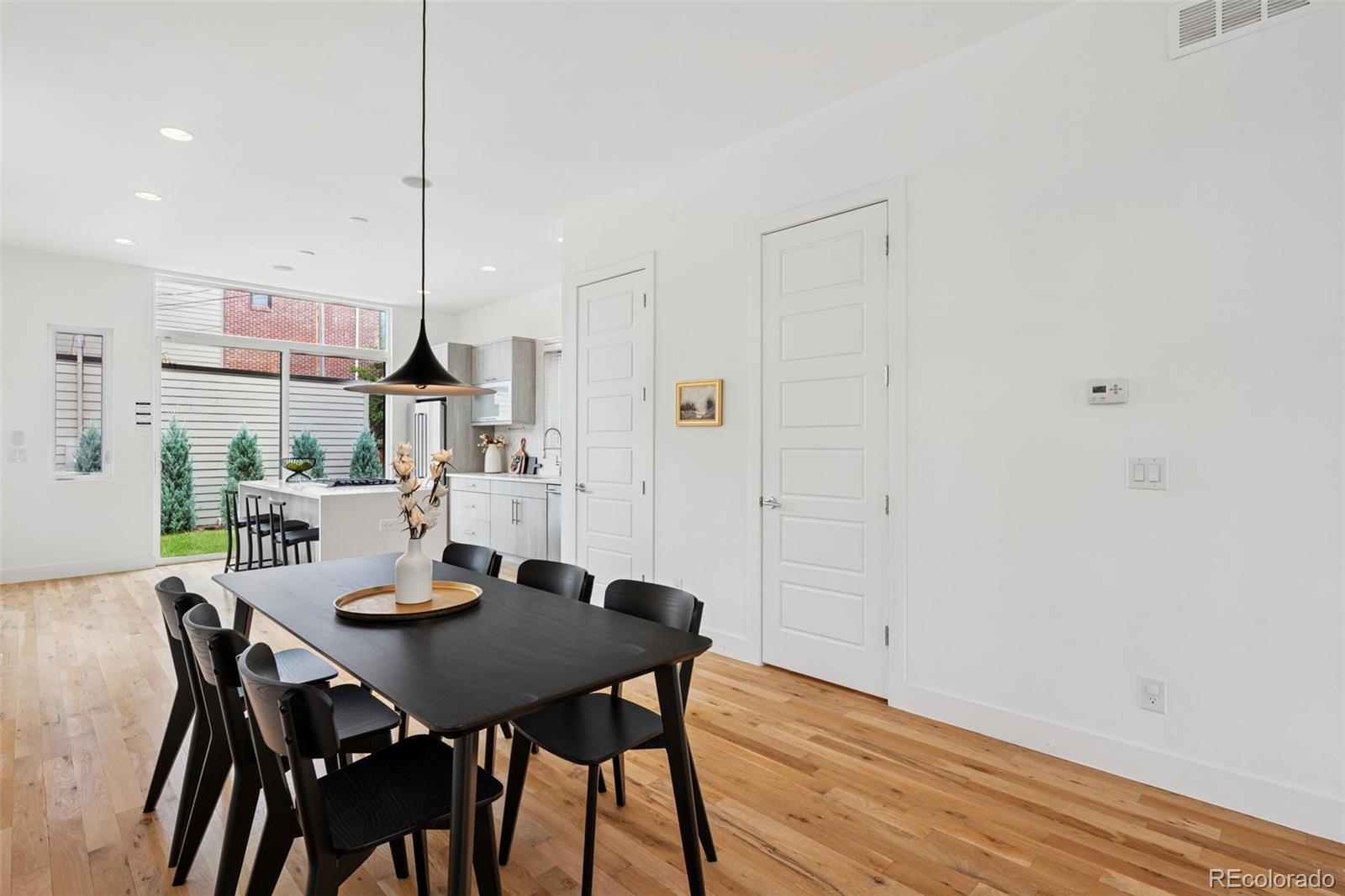 1833 East Jewell Avenue Denver, CO 80210 - Photo 9 of 41 a view of a dining room with furniture and wooden floor